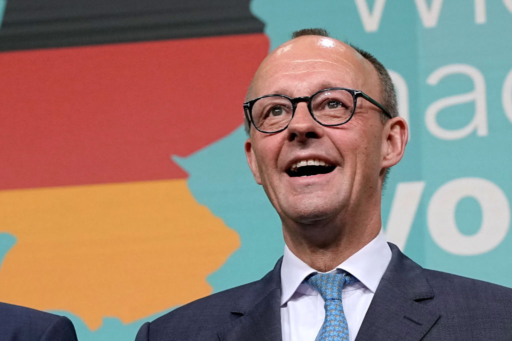 Friedrich Merz with a happy face as he looks at the results of the 2025 German election exit polls