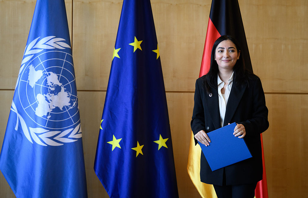Reem Alabali-Radovan, the new German development minister, poses in front of an UN and EU flag